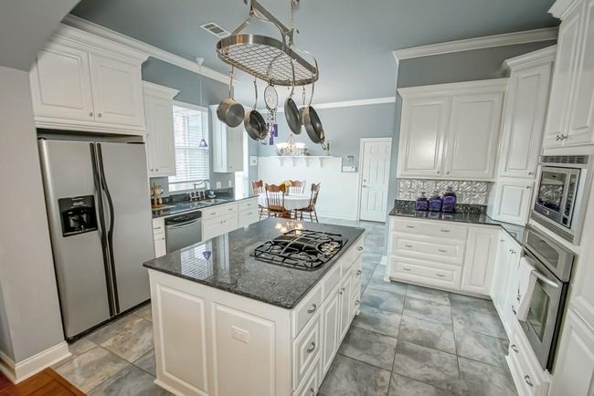 Nice and bright kitchen includes porcelain tile flooring, gas cooktop, stainless steel appliances. | Image 14