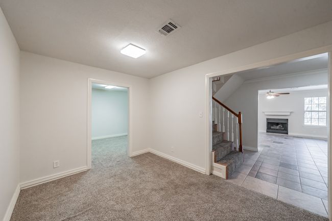 Bonus room featuring ceiling fan and light colored carpet | Image 11