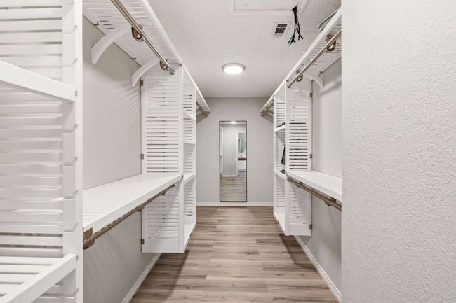 Walk in closet featuring light wood finished floors | Image 35
