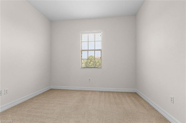 Empty room with light carpet and baseboards | Image 15