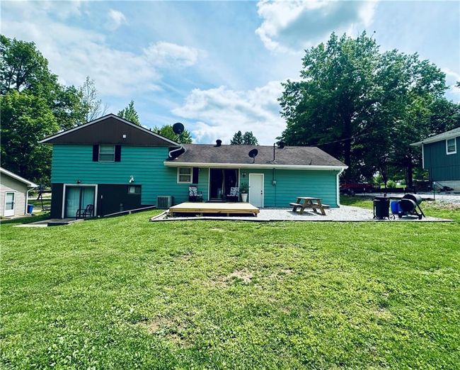 Rear view of house featuring central air condition unit, a deck, and a yard | Image 23