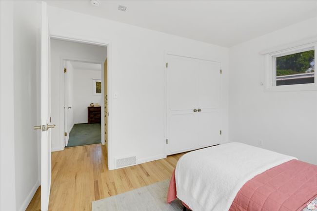 Bedroom featuring light wood finished floors and a closet | Image 12