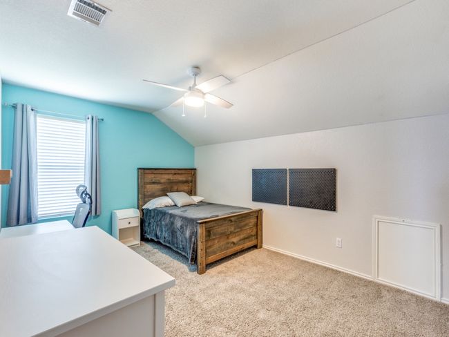 Bedroom featuring vaulted ceiling, light carpet, and a ceiling fan | Image 28