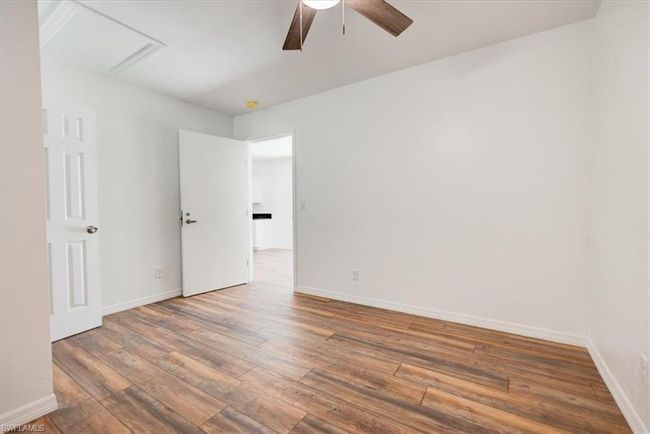 Unfurnished room featuring ceiling fan, hardwood / wood-style floors, and baseboards | Image 36