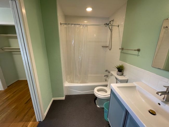 Bathroom with shower / bath combo, vanity, and wood finished floors | Image 11