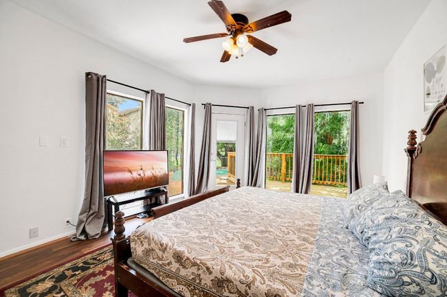 Second primary bedroom with pool view and deck access leading out to pool | Image 15