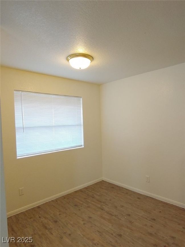 Unfurnished room featuring a textured ceiling and dark hardwood / wood-style floors | Image 6