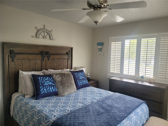 Bedroom featuring ceiling fan | Image 14