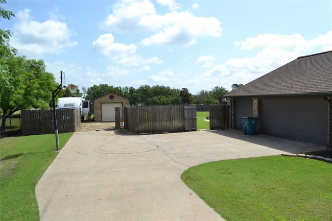 Seperate gated parking for RV with shop. | Image 37