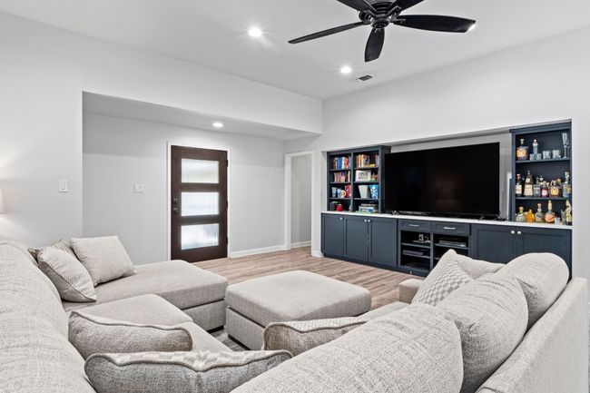 Living area with recessed lighting, visible vents, baseboards, light wood-style flooring, and ceiling fan | Image 7