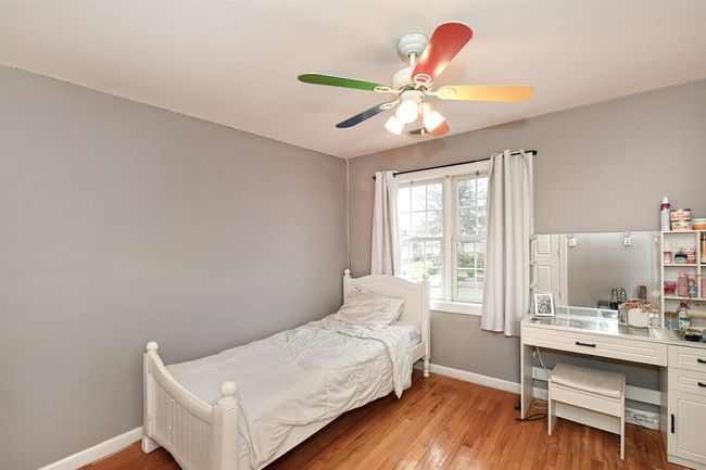 Bedroom with baseboards, a ceiling fan, and light wood finished floors | Image 16