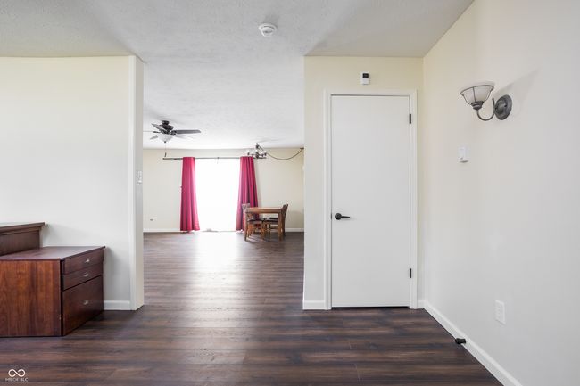 corridor with dark wood-type flooring and a textured ceiling | Image 6