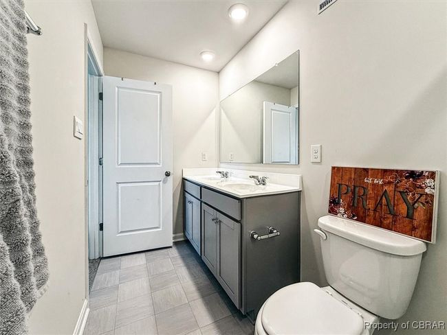 Bathroom featuring toilet, vanity, and baseboards | Image 19
