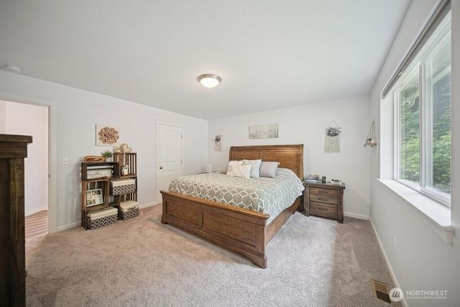 Lovely primary suite where the beauty of trees and tiered backyard area await. | Image 13