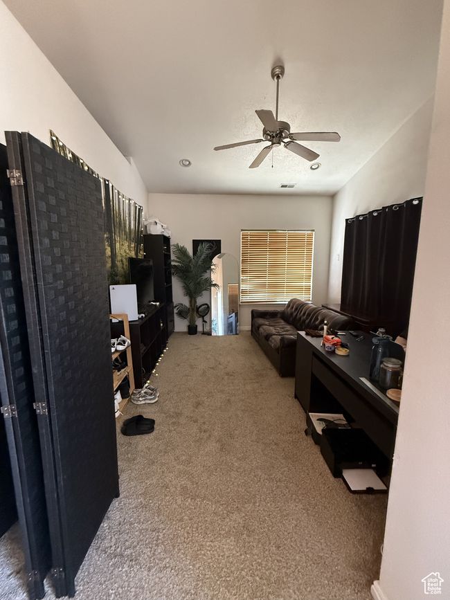 Carpeted living room with ceiling fan | Image 10