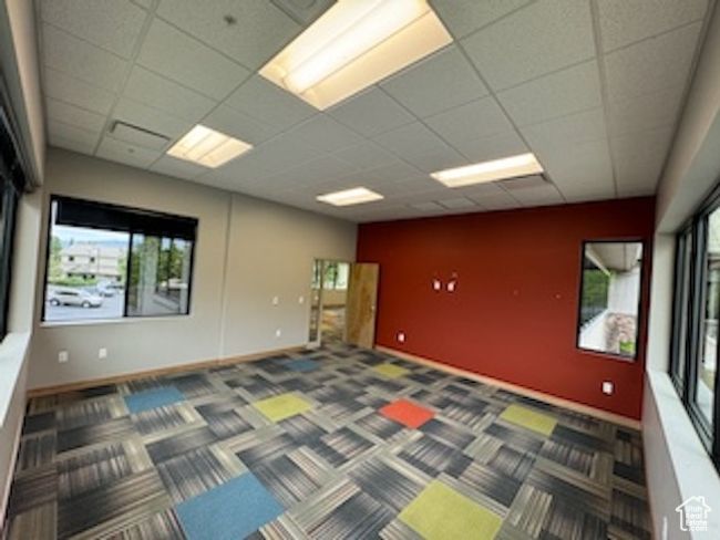 Carpeted spare room with a drop ceiling and baseboards | Image 26