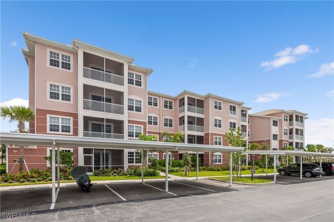 View of building exterior with covered parking | Image 27