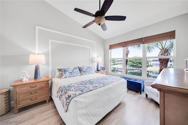 Master Bedroom featuring tall ceiling, Laminate Wood flooring, and a big Lake View with water feature | Image 12
