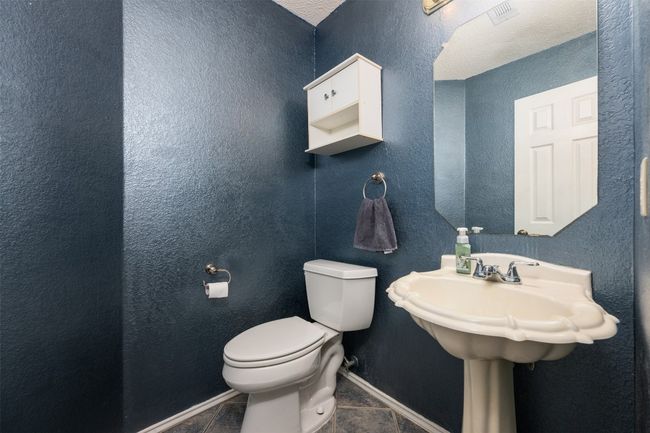 Bathroom with visible vents, toilet, tile patterned flooring, and baseboards | Image 15