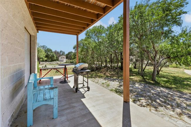 View of patio / terrace featuring grilling area and view of wooded area | Image 27