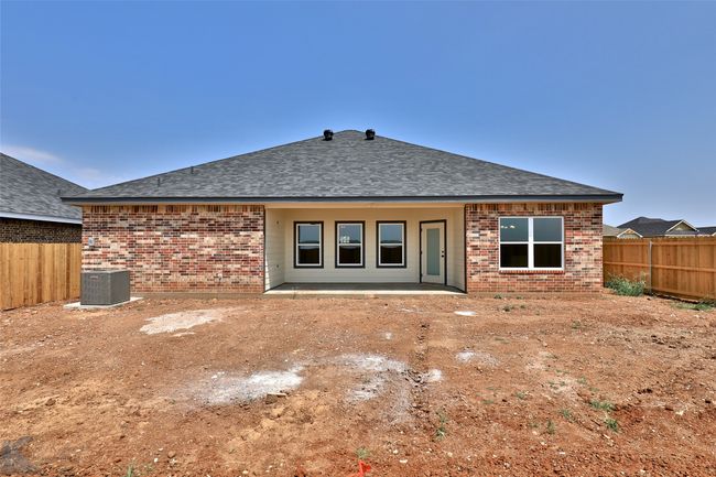 Back of property featuring brick siding, a fenced backyard, and roof with shingles | Image 29