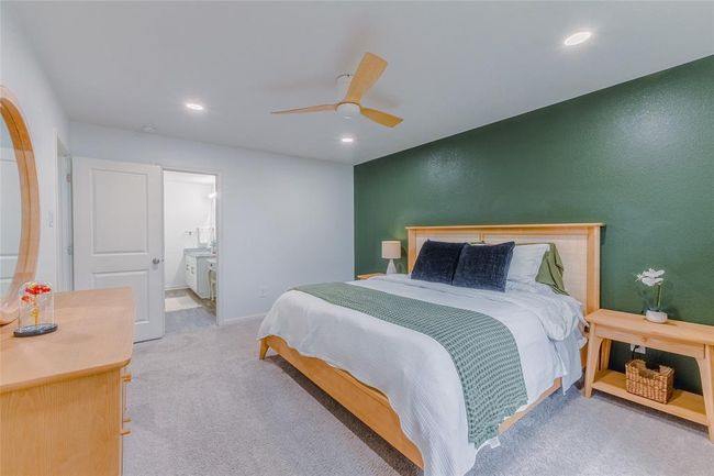 Primary bedroom with view into the owners en suite bathroom and walk in closet beyond. | Image 17