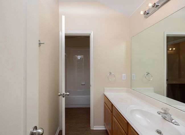 Bathroom featuring vanity, wood finished floors, and vaulted ceiling | Image 28