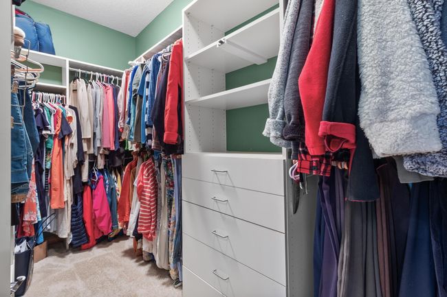 Primary bedroom first walk-in closet with built-in storage. | Image 24