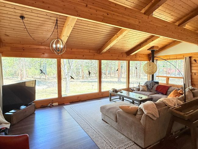 Living room with a chandelier and large picture windows | Image 5
