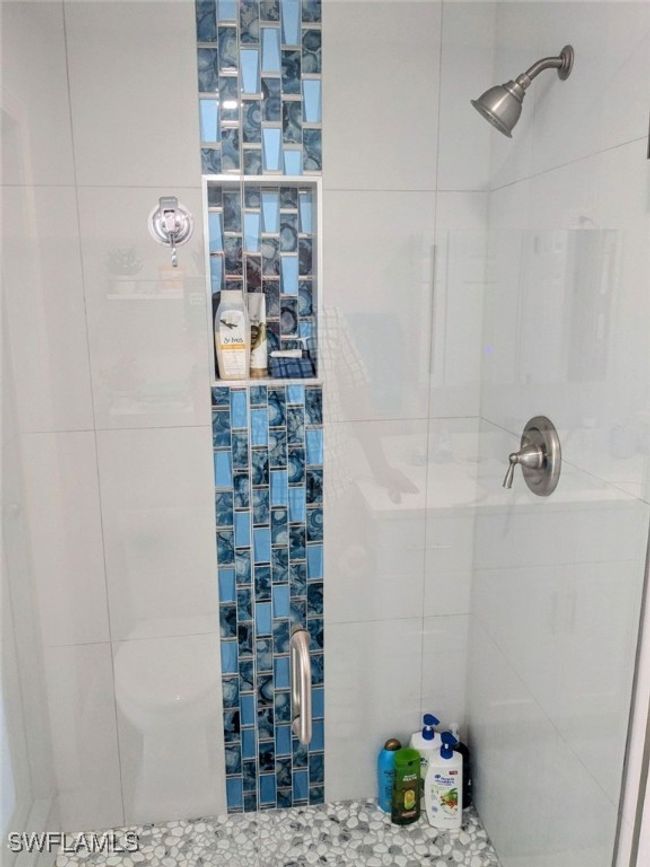 Bathroom featuring a tile shower | Image 35