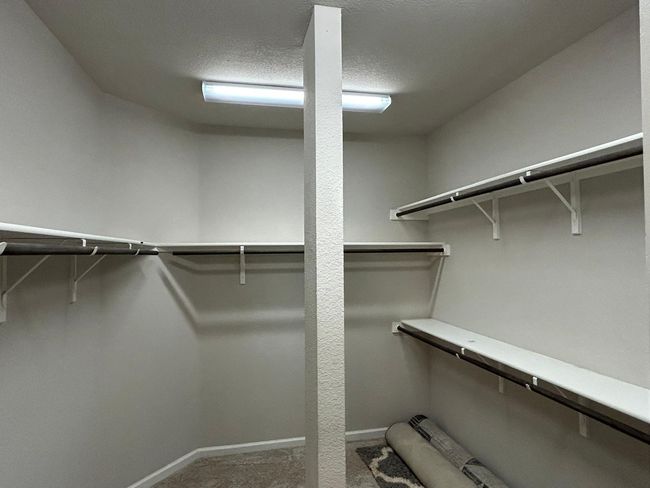 Walk in closet with carpet floors | Image 29