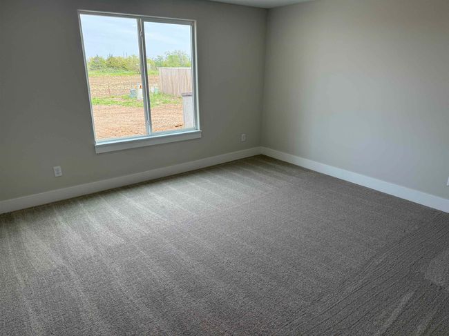Empty room featuring baseboards and carpet | Image 15