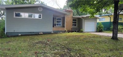 View of front facade featuring a front yard and a garage | Image 3