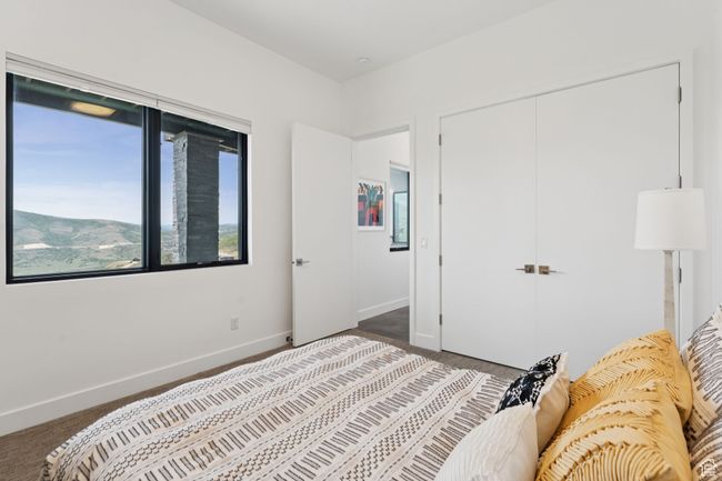 Carpeted bedroom with a closet and baseboards | Image 62