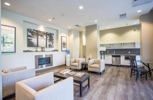 Living area with a glass covered fireplace, recessed lighting, visible vents, and dark wood finished floors | Image 18