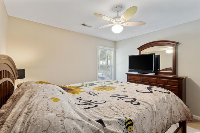 Carpeted bedroom with a ceiling fan and baseboards | Image 24