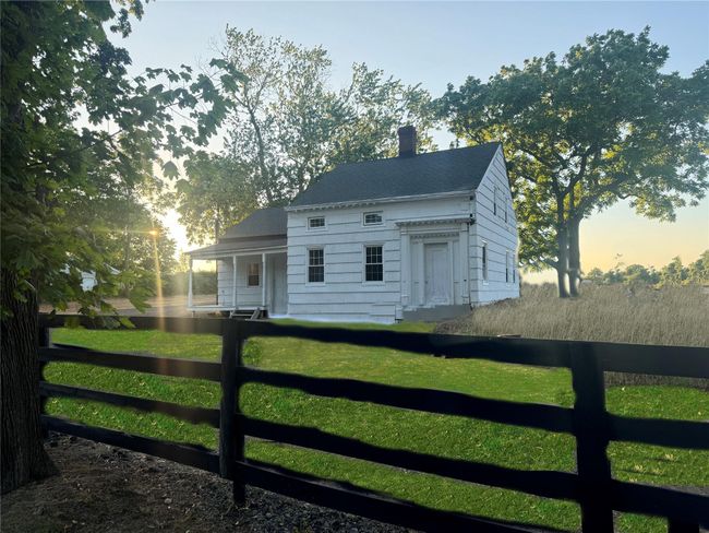 View of front of property featuring a front yard, fence, and a chimney | Image 6