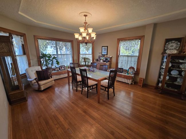 Timeless chandelier, woodwork, flooring in this home | Image 11