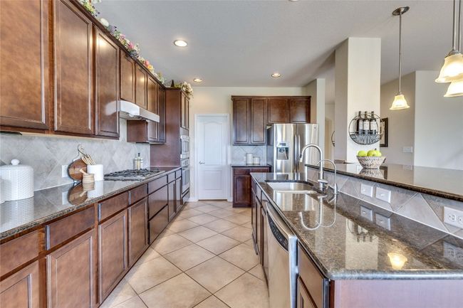Kitchen featuring dark stone countertop | Image 10