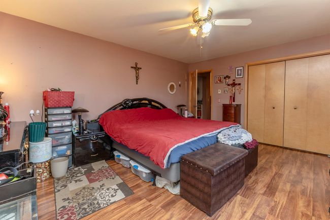 Bedroom with a closet, ceiling fan, and wood finished floors | Image 16