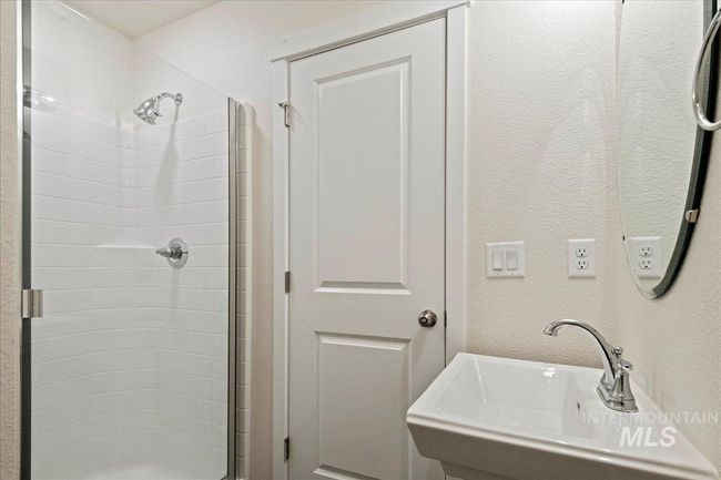 Bathroom with a textured wall and a stall shower | Image 13