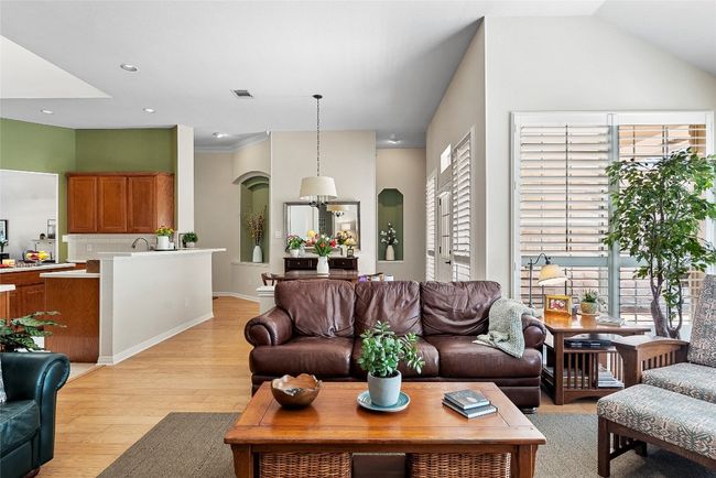 Open to the kitchen and breakfast area, this spacious living room creates a seamless flow for entertaining | Image 11