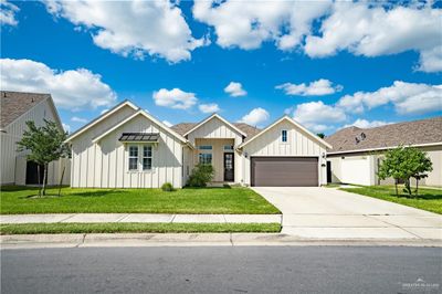 Modern inspired farmhouse featuring a garage and a front lawn | Image 3