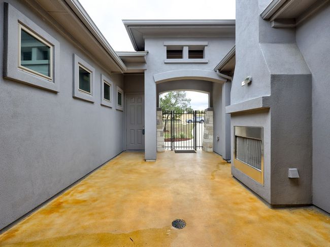 Courtyard with gate, fireplace and stained concrete | Image 4