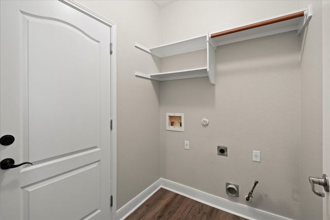Laundry room is next to the breakfast nook and leads to garage. | Image 15