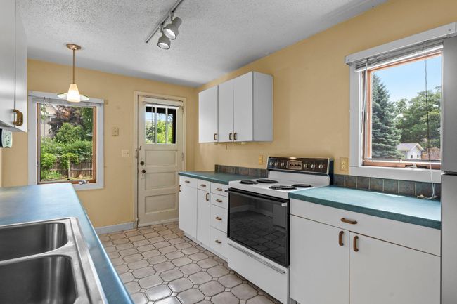 This main level kitchen features ample cabinetry and generous counter space. | Image 10