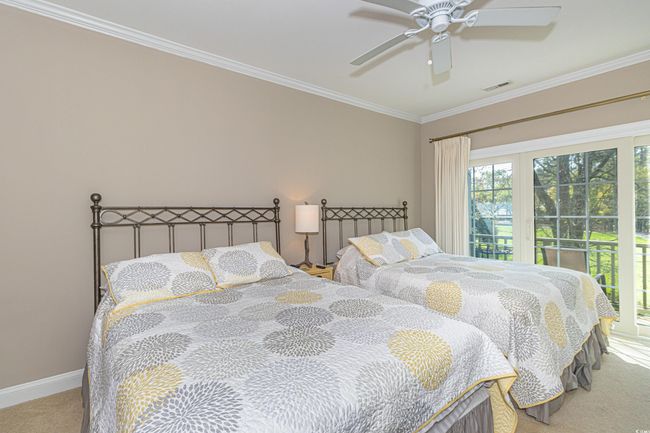 Carpeted bedroom with ornamental molding, baseboards, ceiling fan, and visible vents | Image 22