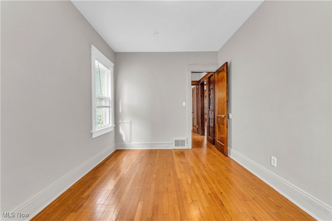 Empty room featuring visible vents, baseboards, and light wood-type flooring | Image 16