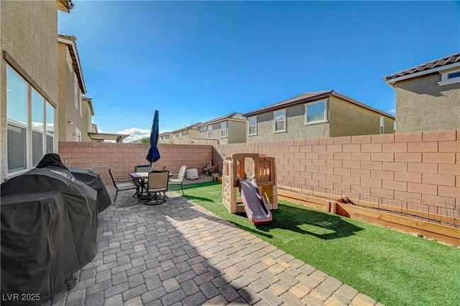Fenced backyard with a patio, a grill, and outdoor dining area | Image 52