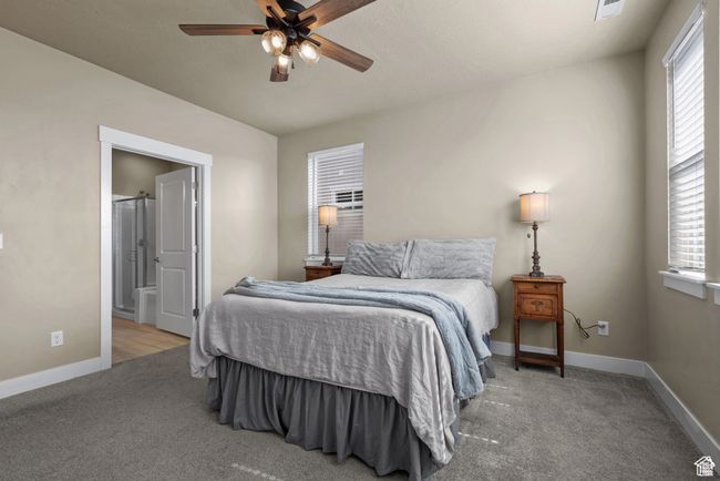 Bedroom featuring baseboards, a ceiling fan, carpet flooring, and visible vents | Image 15